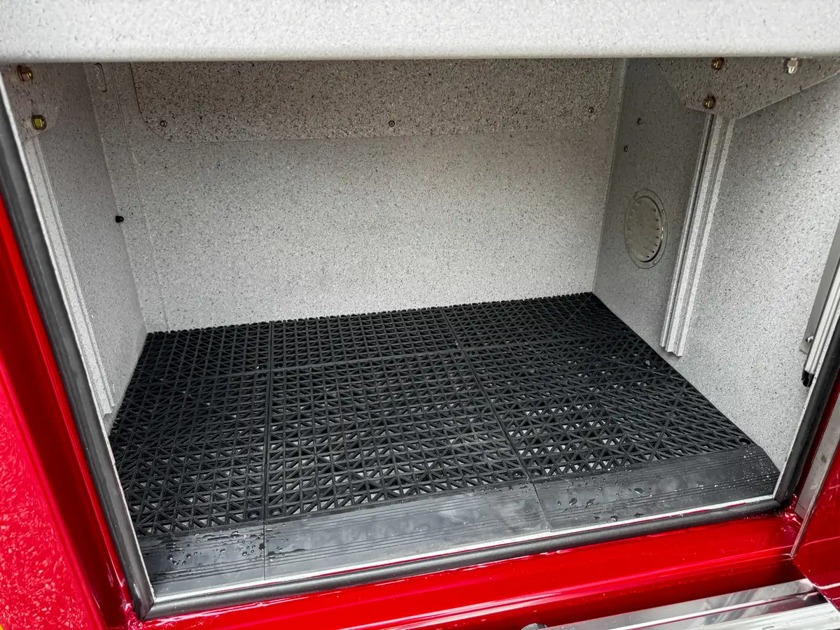 Deep compartment interior close-up with wiring and lower corner vent detail.